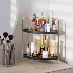 a three tiered shelf with cosmetics and makeup brushes