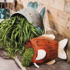 two fish shaped planters sitting next to each other