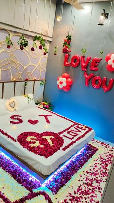 a bed with flowers on it and the words love you spelled out in large letters