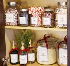 the shelves are filled with different types of candy canes and candies in glass jars