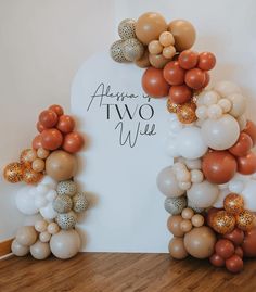 an arch made out of balloons with the words above it that says affair two wine