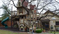 a children's play area with a slide and tree house