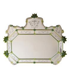 an ornate mirror with green leaves on it