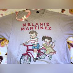 a t - shirt that says melanie martinez on it