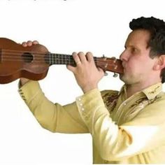 a man is playing the ukulele with his fingers