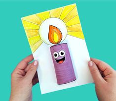 someone holding up a card with an image of a candle on it and the sun above