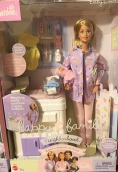 the barbie doll is in its box with her clothes and baby items on it's chest