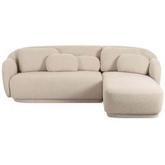 a large sectional couch with pillows on the back and footrests, in beige