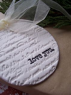 a white ornament with the words love you on it