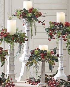 christmas decorations with candles and greenery on them