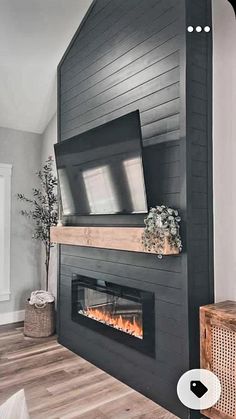 a living room with a fireplace and tv mounted on the wall