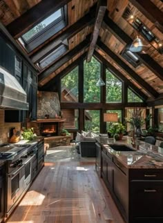 an open kitchen and living room with wood flooring, vaulted ceiling, and large windows