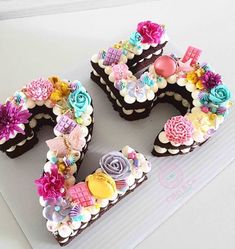 the number 50 made out of cupcakes is decorated with flowers