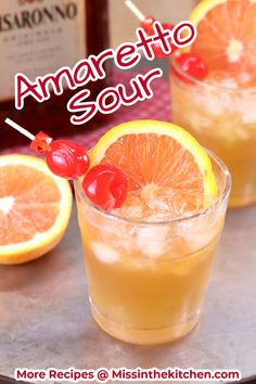 two glasses filled with orange juice and garnished with cherries