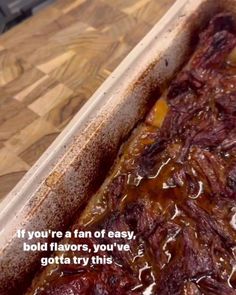 a baking dish filled with food on top of a wooden table