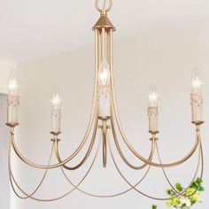 a chandelier with candles hanging from it