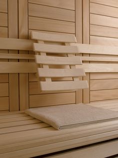 a wooden bench with towels on it in a saunach or steam bath room