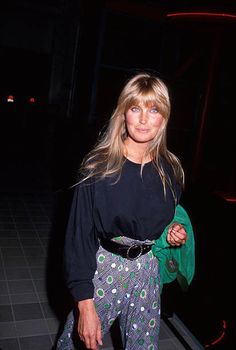 a woman in black shirt and patterned pants