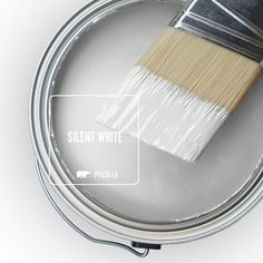 a paint can with a brush on top of it