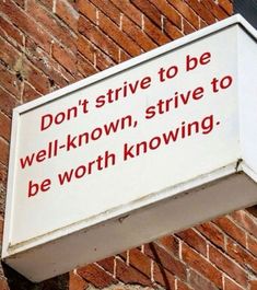 a sign on the side of a brick building that says don't strive to be well - known, strive to be worthing