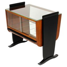 a wooden and glass cabinet with black legs