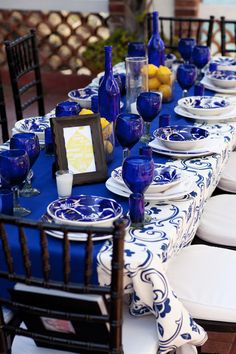 a table set with blue and white plates