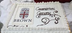 a cake that is sitting on top of a table with writing and symbols on it