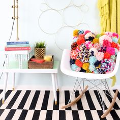 a white chair sitting on top of a black and white checkered floor next to a wall