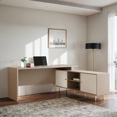 a desk with a laptop on top of it in a room next to a window