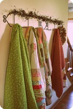 towels are hanging on the wall next to an iron rack