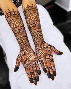 two hands with henna designs on them