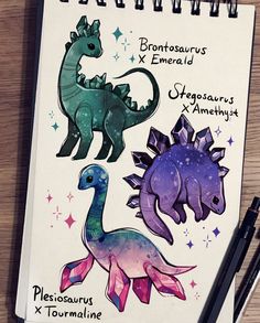 an open notebook with drawings of dinosaurs and stars on the cover, along with two black pens