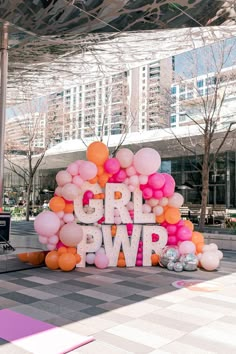 a large balloon arch with the word girl pwp spelled out in white letters