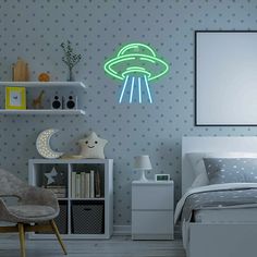 a bed room with a neatly made bed and a neon alien sign above the bed