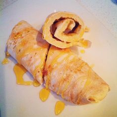 some food is laying on a white plate and drizzled with sauces