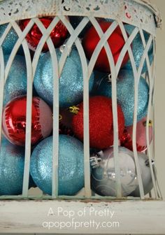 a white basket filled with blue and red ornaments