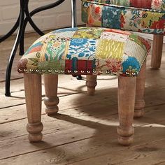 an upholstered chair sitting on top of a wooden floor