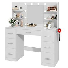 a white vanity with lights and drawers