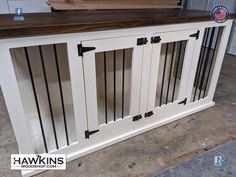 a white cabinet with black bars on the top and bottom, sitting in a garage