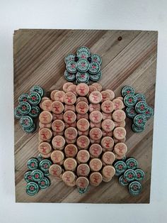 a group of buttons sitting on top of a wooden table next to each other in the shape of a turtle