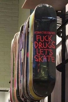 a bunch of skateboards that are hanging up