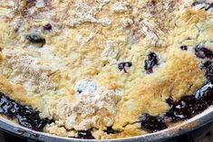 a blueberry cobbler is shown in a pan