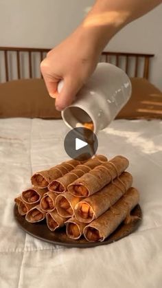 a person is pouring milk on some pita breads that are stacked on a plate