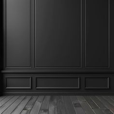 an empty room with black walls and wooden floors