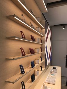 a man standing in front of a display case with many different items on shelves and lights