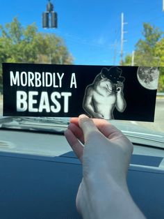 someone is holding up a sticker that says, morbilly a beast