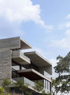 a tall building sitting on top of a lush green hillside