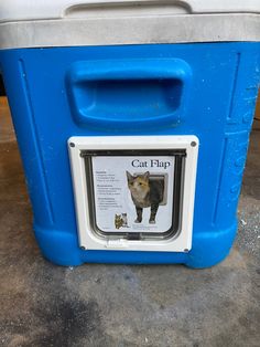 a blue and white cooler with a cat flap on it