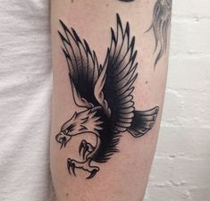 an eagle and bird tattoo on the arm