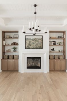 an empty living room with white walls and wood floors